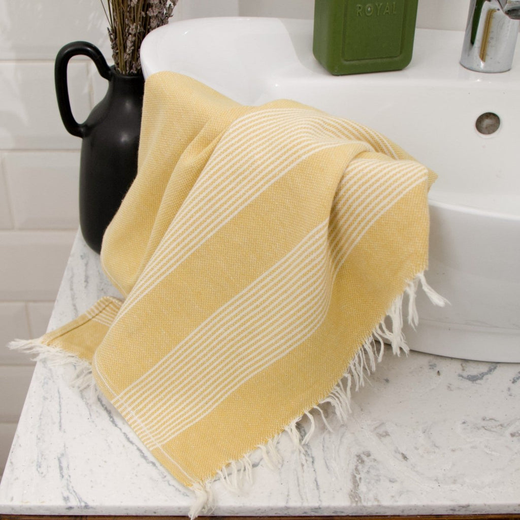 Anza Mustard Amber Turkish Hand Towel on bathroom sink     