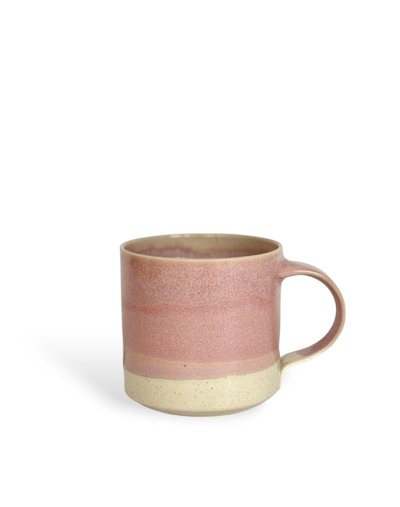 A pink and beige two-toned gradient color ceramic mug.