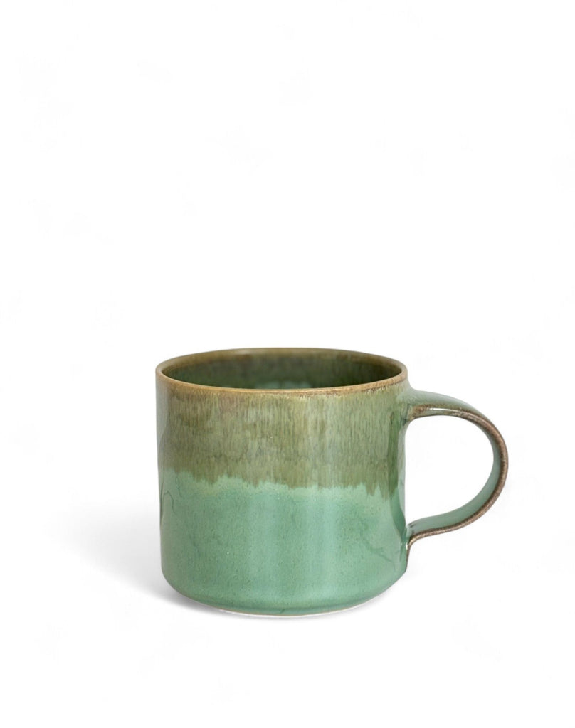 A green and brown two-toned gradient color ceramic mug with glossy finish.